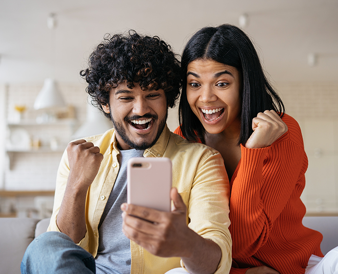 Happy couple celebrating after getting their personal loan approved